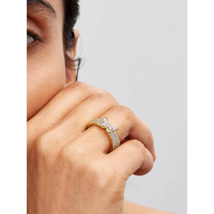 Model wearing Pandora Sparkling Butterfly Bold Ring on finger with gold-tone butterfly and sparkling stones