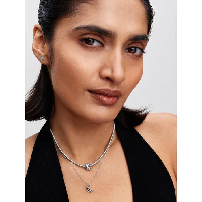 Model wearing Pandora Sparkling Moon stud earrings and matching moon necklace in sterling silver