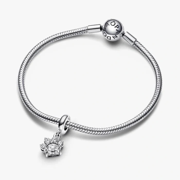 Elevate your love for your best friend with the Sparkling Pet Paw Print Dangle Charm.