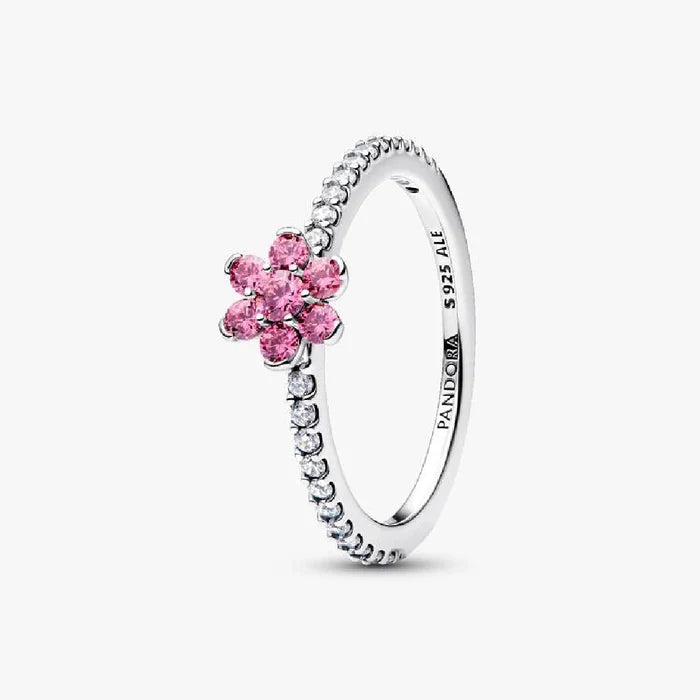 A Pandora flower ring featuring a pink sapphire set in elegant white gold.