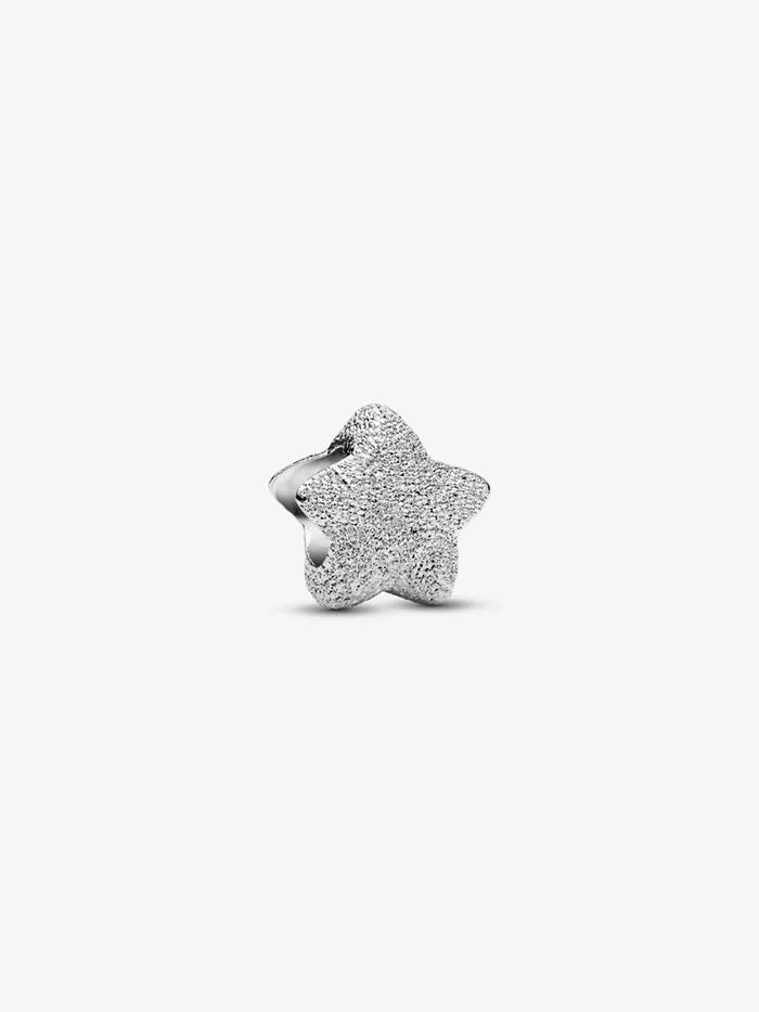 Front view of the sterling silver textured star charm highlighting its sparkling surface.