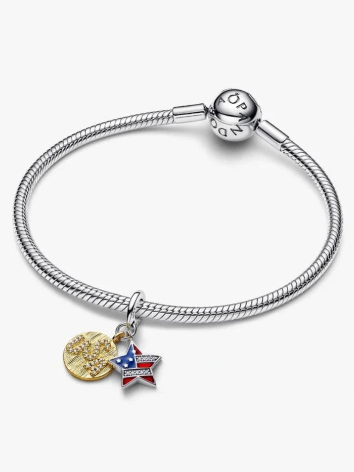 Sterling silver-tone dangle charm featuring a red, white, and blue enamel star with crystal accents and a gold-tone heart, designed for charm bracelets and necklaces.