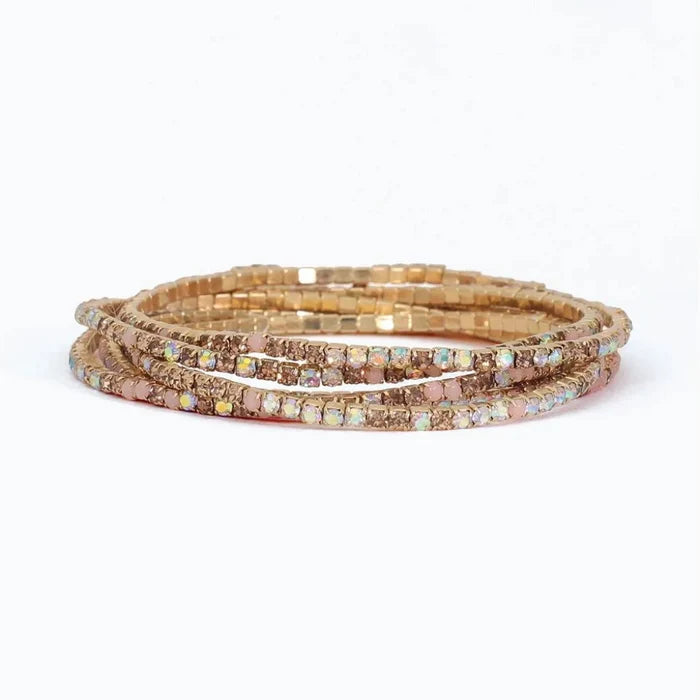 Periwinkle bracelet with six strands of blush, champagne, and AB crystals in a sparkling layered design.