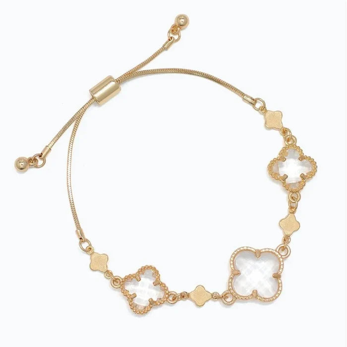 gold bracelet featuring clover accents with faceted clear crystals for a sparkling and elegant look.
