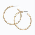 Periwinkle hammered matte gold hoop earrings with a textured finish and classic circular design