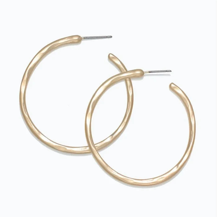 Periwinkle hammered matte gold hoop earrings with a textured finish and classic circular design