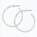Periwinkle hammered silver hoop earrings with a textured matte finish and classic circular design.