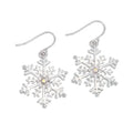 Periwinkle silver snowflake earrings featuring sparkling crystal accents, perfect for elegant winter and holiday looks.