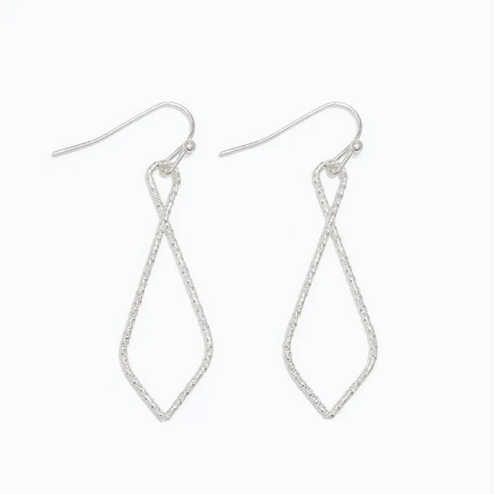 The sculpted open-drop silhouette adds graceful dimension without overwhelming your look.