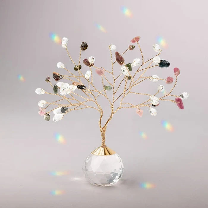 Suncatcher Tree of Life with tourmaline crystals hanging in sunlight casting rainbow reflections
