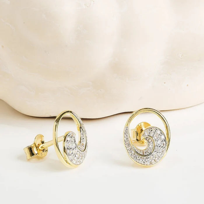 Wave shaped earrings on a light background