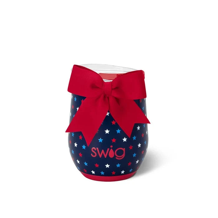 A wine glass adorned with a red bow and scattered stars, creating a festive and elegant appearance.
