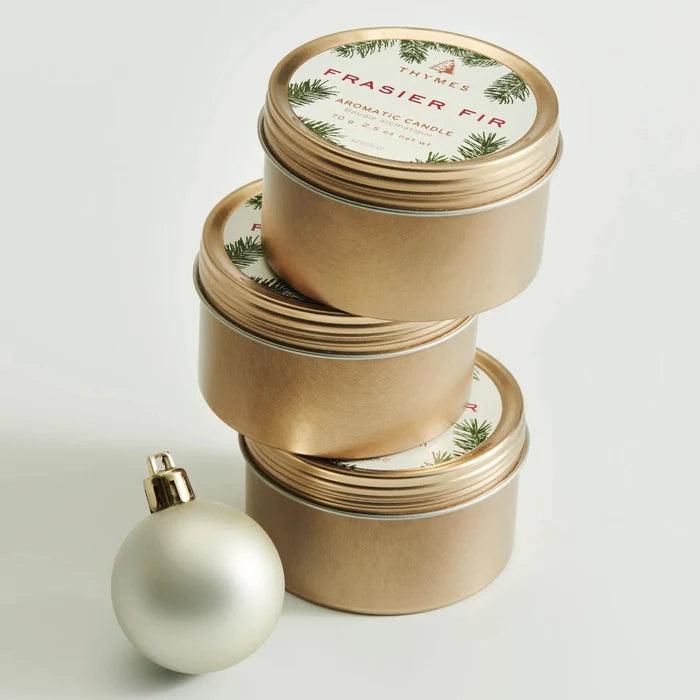 Frasier Fir® Travel Tin Candle with a fresh evergreen-inspired fragrance in a compact travel-size container.