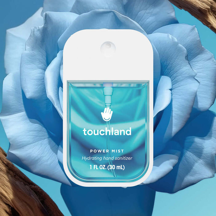 Touchland hand sanitizer bottle with blue floral background