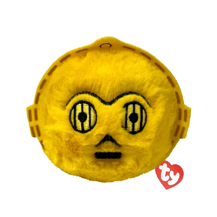 A yellow face toy with eyes set against a solid black background.