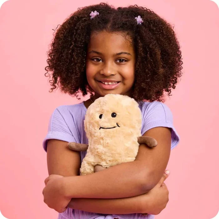 Young girl holding a teddy bear against a pink background