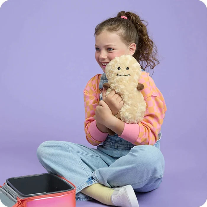 Young girl holding a plush toy against a purple background