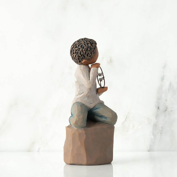 "Willow Tree Love You Too figurine – boy with darker skin kneeling on a pedestal, holding a wire circle that says 'love you' in script."
