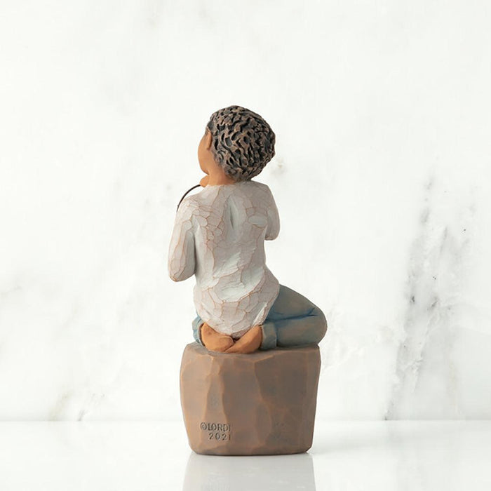 "Willow Tree Love You Too figurine – boy with darker skin kneeling on a pedestal, holding a wire circle that says 'love you' in script."