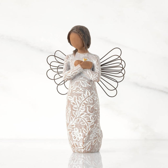 "Willow Tree Remembrance angel figurine with darker skin tone – hand-painted resin figure with floral design, wire wings, and gold heart for memory and healing."