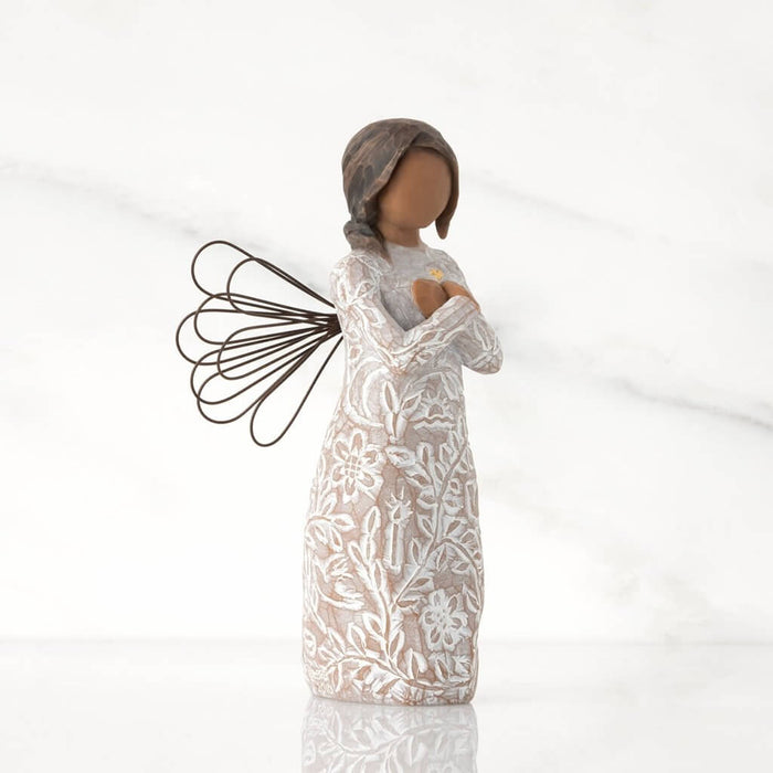 "Willow Tree Remembrance angel figurine with darker skin tone – hand-painted resin figure with floral design, wire wings, and gold heart for memory and healing."