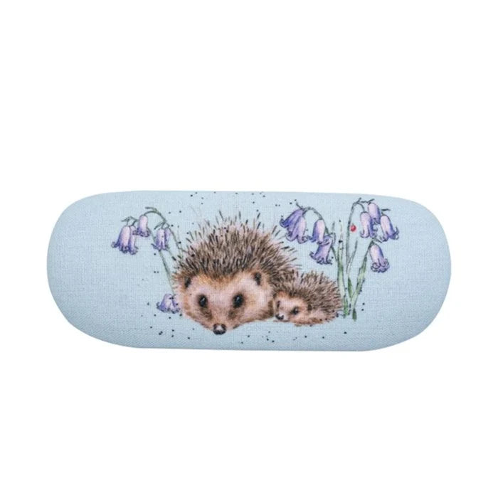 A hedgehog nestled among bluebells on a vibrant blue background, showcasing a serene natural scene.